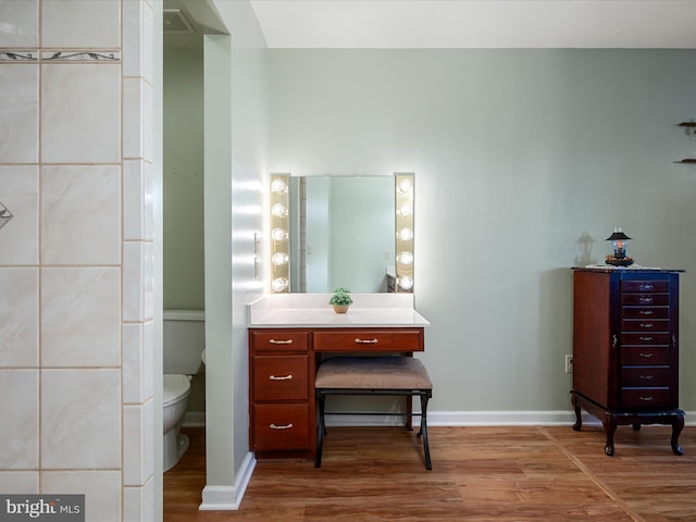 5409 Smith Creek Rd, New Market, VA 22844 - bathroom featuring wood finished floors, vanity, baseboards, toilet, and visible vents