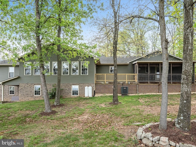 5409 Smith Creek Rd, New Market, VA 22844 - rear view of house featuring a sunroom, brick siding, a yard, and a deck