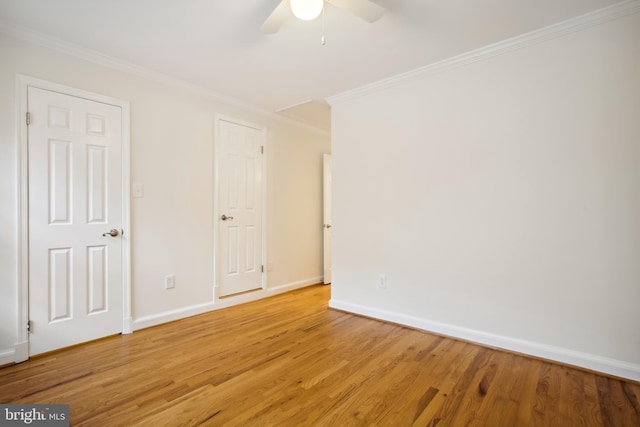 unfurnished bedroom with ornamental molding, light wood-style floors, baseboards, and ceiling fan