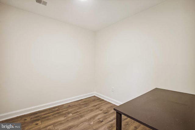 spare room with wood finished floors and baseboards