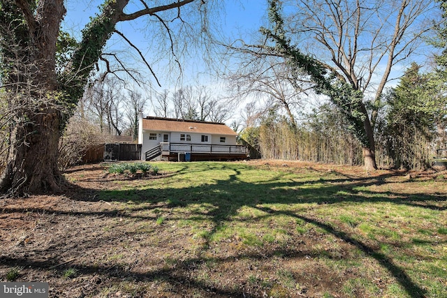 view of yard with fence and a deck