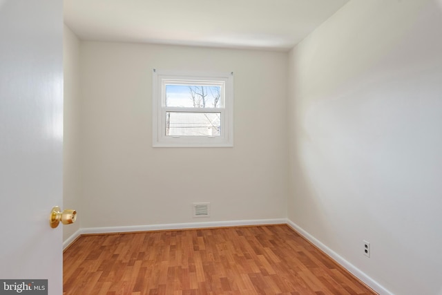 spare room with light wood-style flooring, baseboards, and visible vents