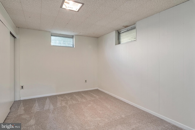 basement featuring baseboards and carpet