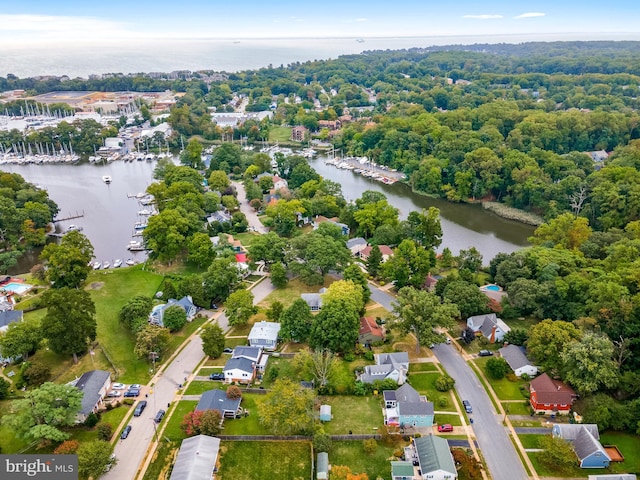 drone / aerial view featuring a residential view and a water view