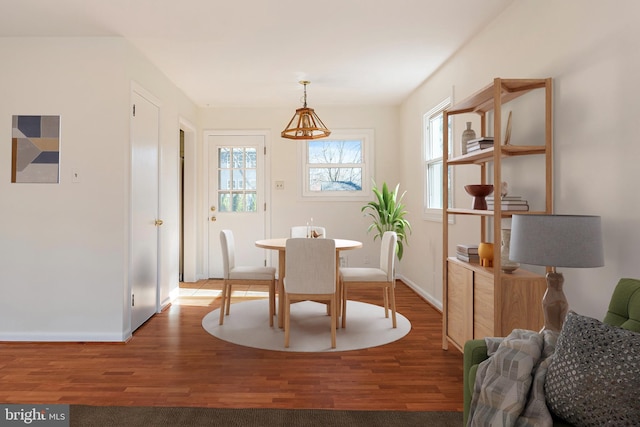 dining room featuring baseboards and wood finished floors
