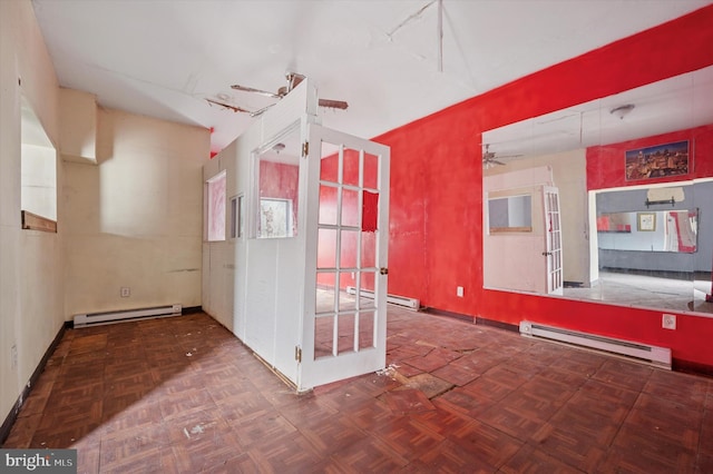 empty room featuring ceiling fan and baseboard heating