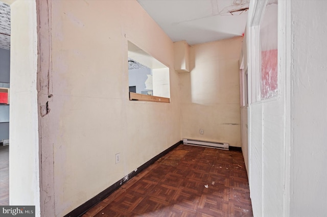 interior space featuring baseboards and a baseboard heating unit