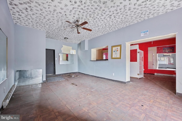 spare room featuring a baseboard radiator, baseboards, a baseboard heating unit, and ceiling fan