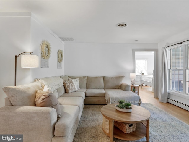living room featuring light wood finished floors and visible vents