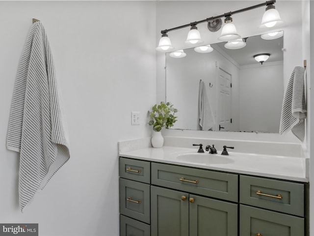 bathroom with ornamental molding and vanity