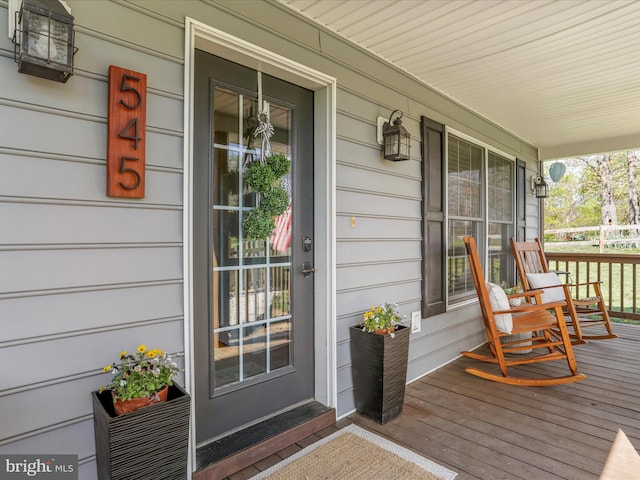 view of exterior entry with a porch