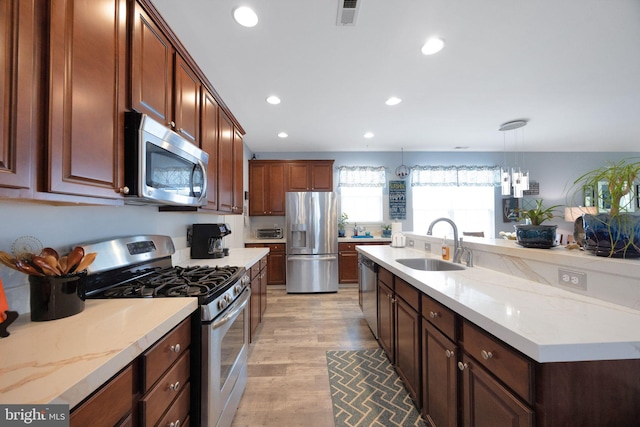 29 Embassy, Woolwich Twp, NJ 08085 - kitchen with appliances with stainless steel finishes, recessed lighting, light wood-type flooring, decorative light fixtures, and an island with sink