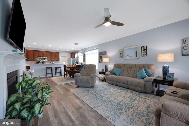 29 Embassy, Woolwich Twp, NJ 08085 - living room featuring light wood-type flooring, a ceiling fan, a fireplace, and recessed lighting