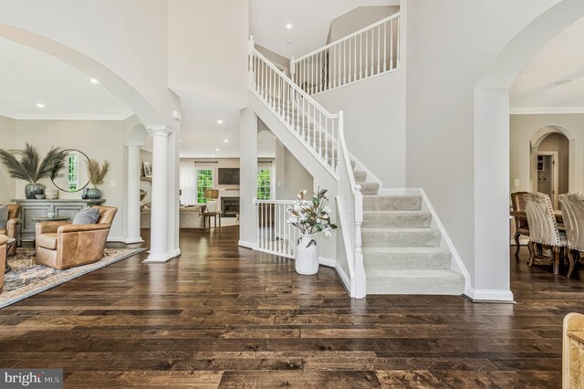630 Good Shepherd Way, Owings, MD 20736 - entrance foyer featuring arched walkways, baseboards, stairs, hardwood / wood-style flooring, and ornamental molding