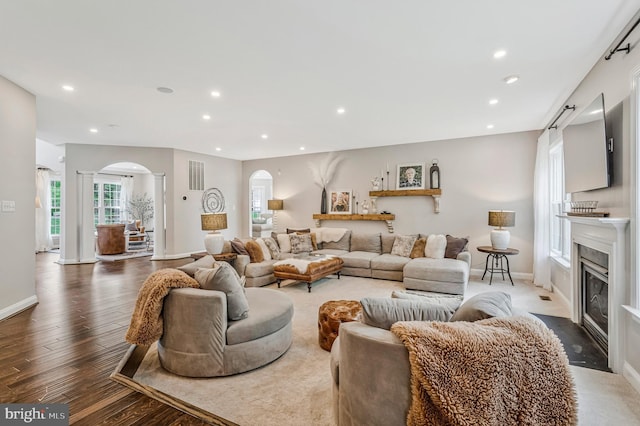 630 Good Shepherd Way, Owings, MD 20736 - living area with a fireplace with flush hearth, arched walkways, decorative columns, visible vents, and recessed lighting