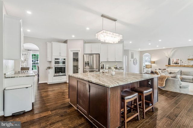 630 Good Shepherd Way, Owings, MD 20736 - kitchen with arched walkways, dark wood-style flooring, stainless steel appliances, and a sink