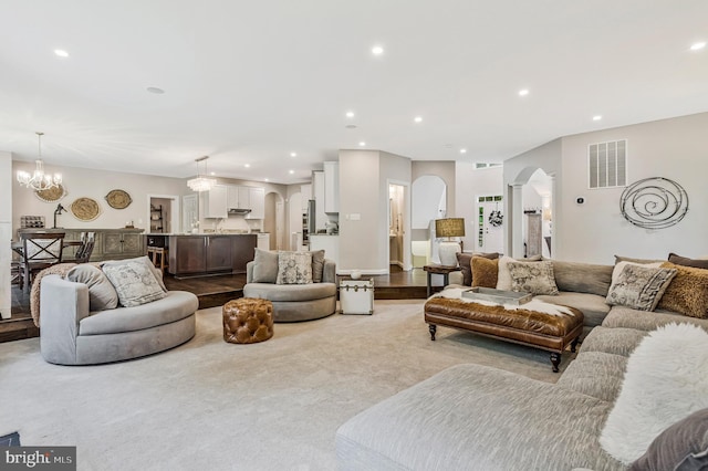 630 Good Shepherd Way, Owings, MD 20736 - living area featuring an inviting chandelier, visible vents, arched walkways, and recessed lighting