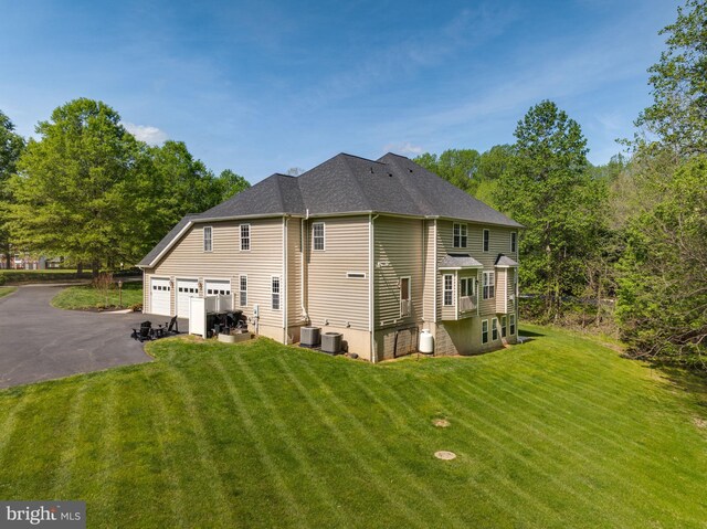 630 Good Shepherd Way, Owings, MD 20736 - rear view of house featuring a yard, an attached garage, driveway, and central AC