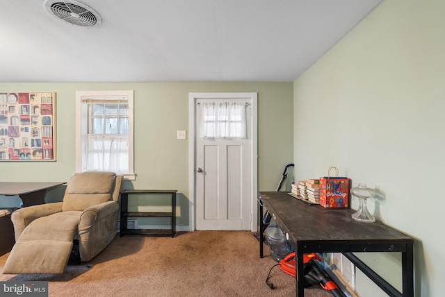 entryway with visible vents and carpet floors