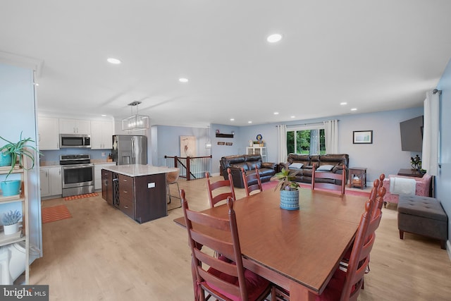 dining area featuring light wood-type flooring and recessed lighting