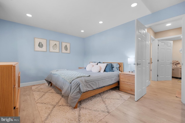 bedroom with light wood-style floors, recessed lighting, and baseboards