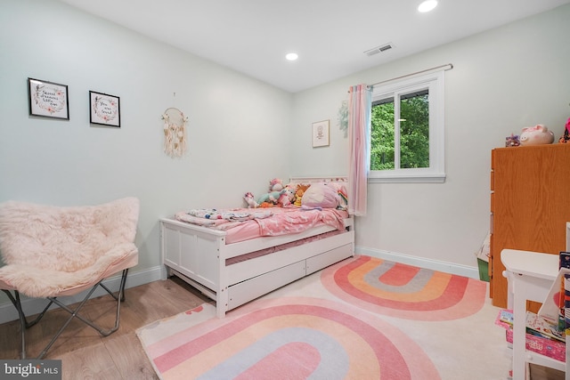 bedroom featuring wood finished floors, recessed lighting, and baseboards