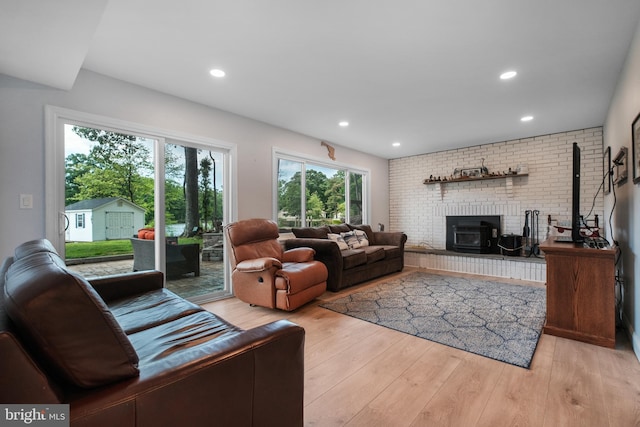 living room with light wood finished floors and recessed lighting