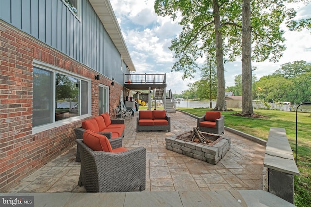 view of patio / terrace featuring an outdoor living space with a fire pit, stairway, and a wooden deck