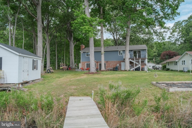 view of grassy yard featuring an outbuilding and stairway