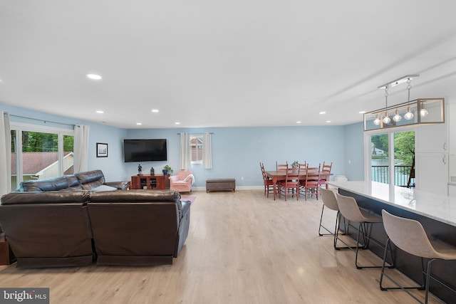 living room with light wood finished floors and recessed lighting