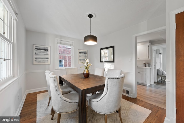 9301 Mintwood St, Silver Spring, MD 20901 - dining space featuring baseboards, dark wood finished floors, and visible vents