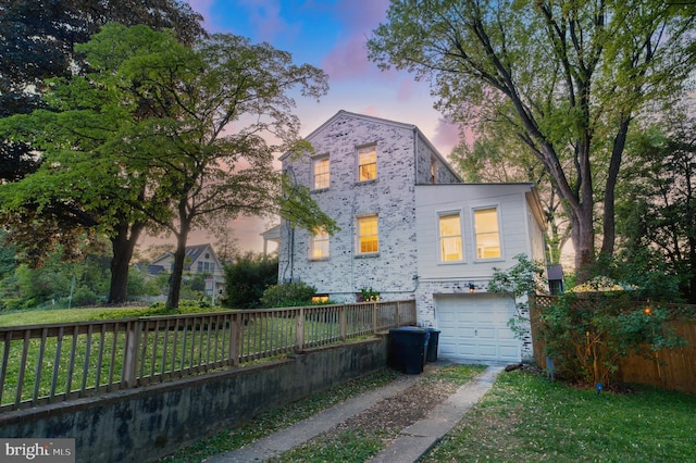 9301 Mintwood St, Silver Spring, MD 20901 - view of front facade with brick siding, fence, driveway, and a garage