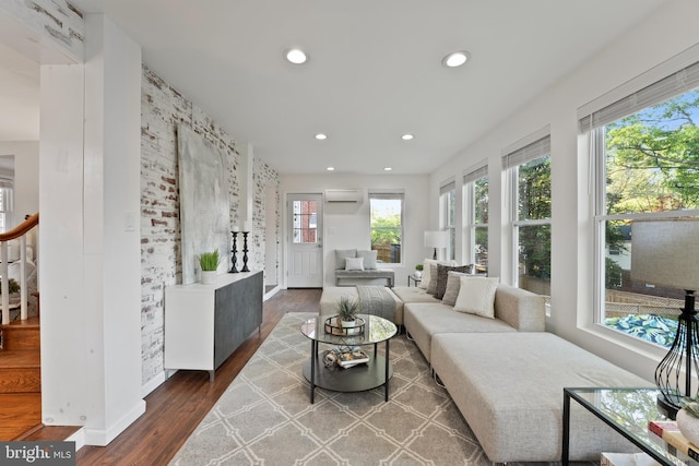 9301 Mintwood St, Silver Spring, MD 20901 - living area featuring wood finished floors, stairway, baseboards, an AC wall unit, and recessed lighting