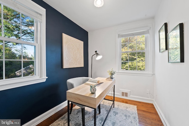 9301 Mintwood St, Silver Spring, MD 20901 - home office featuring baseboards, wood finished floors, and visible vents