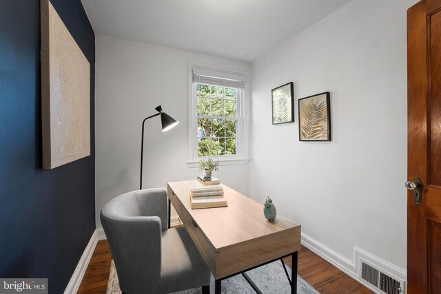 9301 Mintwood St, Silver Spring, MD 20901 - home office with dark wood-style flooring, baseboards, and visible vents