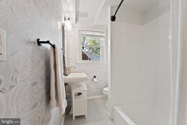 9301 Mintwood St, Silver Spring, MD 20901 - bathroom with tile patterned flooring, baseboards, toilet, shower / bathtub combination, and wallpapered walls