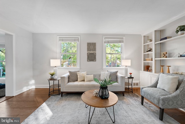 9301 Mintwood St, Silver Spring, MD 20901 - living area with baseboards, visible vents, built in features, and wood finished floors