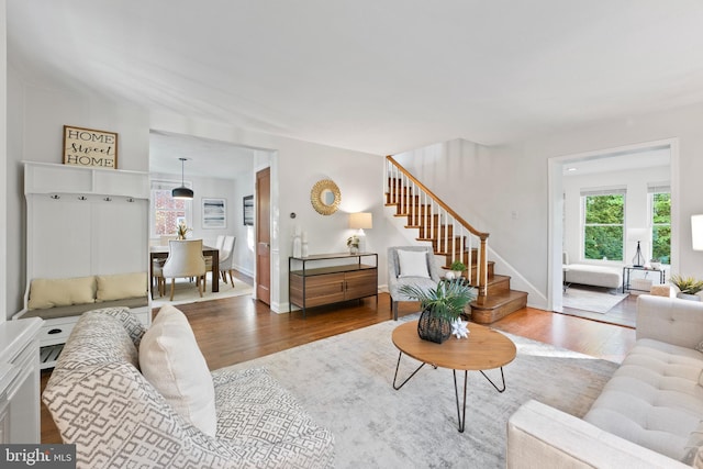 9301 Mintwood St, Silver Spring, MD 20901 - living room featuring baseboards, stairs, and wood finished floors