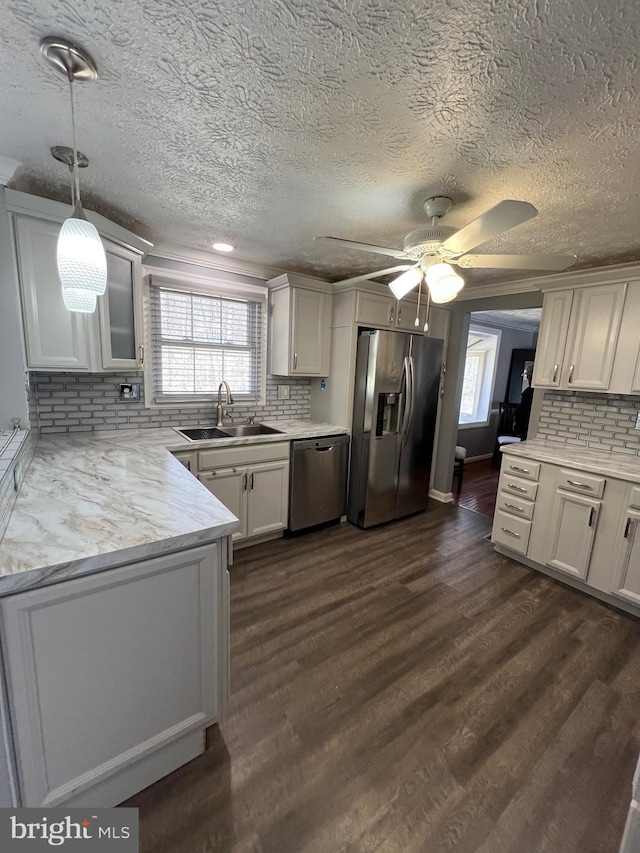 10808 Timberline Dr, Upper Marlboro, MD 20772 - kitchen featuring stainless steel appliances, decorative backsplash, a sink, dark wood-style floors, and ceiling fan