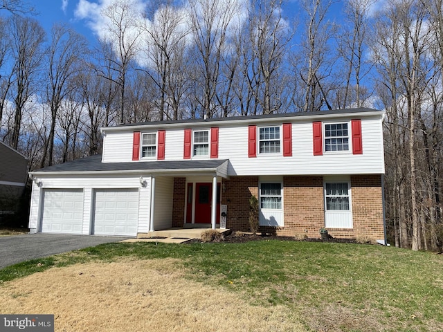 10808 Timberline Dr, Upper Marlboro, MD 20772 - view of front facade featuring a front lawn, brick siding, and aphalt driveway