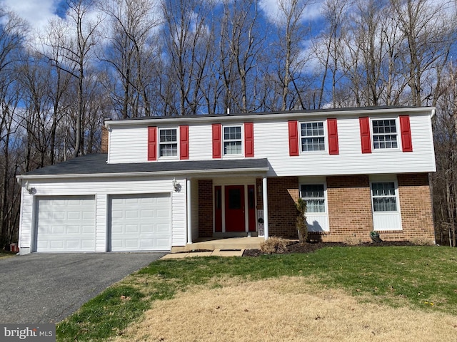 10808 Timberline Dr, Upper Marlboro, MD 20772 - view of front facade with a front lawn, a garage, brick siding, and aphalt driveway