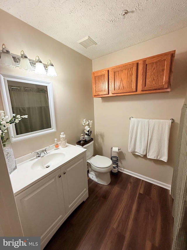 2440 Blue Spring Ct Unit 301, Odenton, MD 21113 - bathroom featuring wood finished floors, vanity, toilet, and a textured ceiling