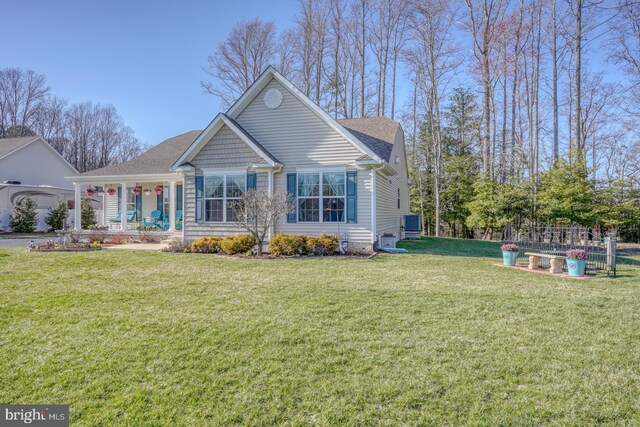 21555 Waterview Rd, Lewes, DE 19958 - view of front of house with covered porch, a front lawn, and roof with shingles