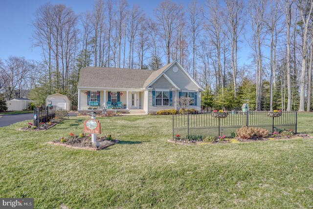 21555 Waterview Rd, Lewes, DE 19958 - view of front of property with fence, an outdoor structure, a porch, and a front yard