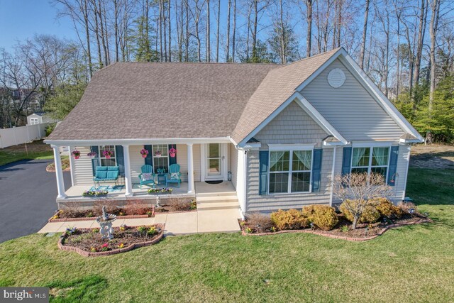 21555 Waterview Rd, Lewes, DE 19958 - view of front facade with a porch, driveway, roof with shingles, and a front lawn