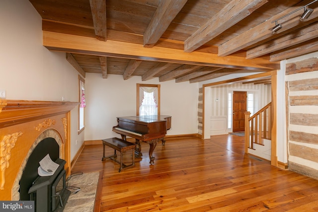 sitting room with wood ceiling, baseboards, and light wood-type flooring