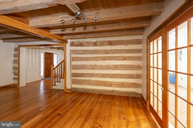 interior space featuring wood ceiling, a wealth of natural light, hardwood / wood-style flooring, and beamed ceiling