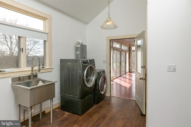 washroom featuring independent washer and dryer, dark wood-style flooring, laundry area, a sink, and water heater