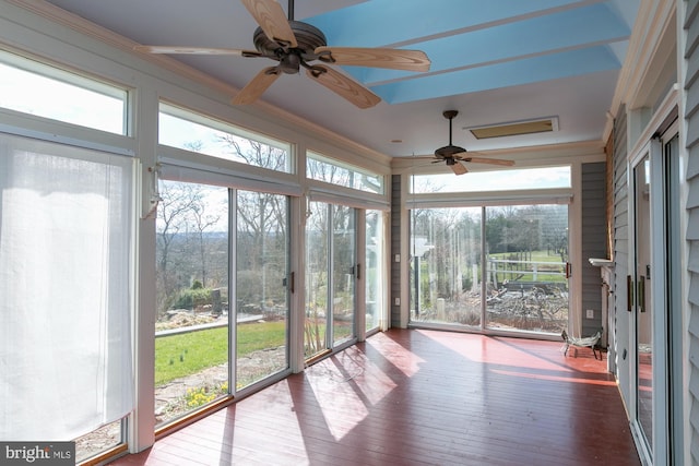 unfurnished sunroom featuring plenty of natural light, ornamental molding, and hardwood / wood-style floors