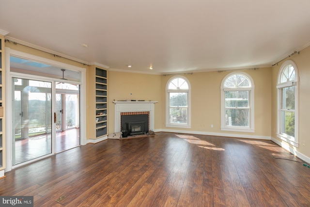 unfurnished living room featuring a fireplace, baseboards, ornamental molding, and wood-type flooring